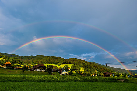 photo of rainbow over village during daytime thumbnail