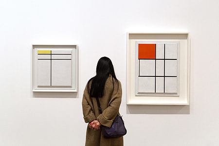 A woman reflects on art by Piet Mondrian in the Tate Modern art gallery in London thumbnail