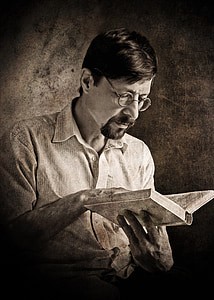 man wearing eyeglasses reading book thumbnail