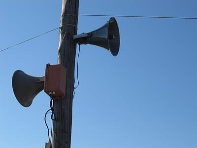 two gray megaphones on brown electric post thumbnail