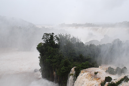 aerial view of waterfalls covered with fog thumbnail