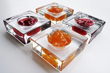 four square clear glass containers filled with substances thumbnail