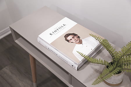 Kinfolk book on top of gray wooden desk thumbnail
