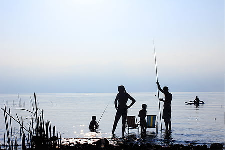 silhouette photo of four person holding fishing rods thumbnail