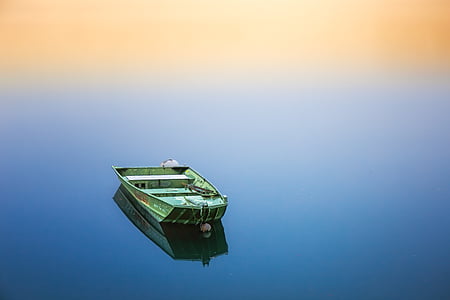 green jon boat on body of water thumbnail