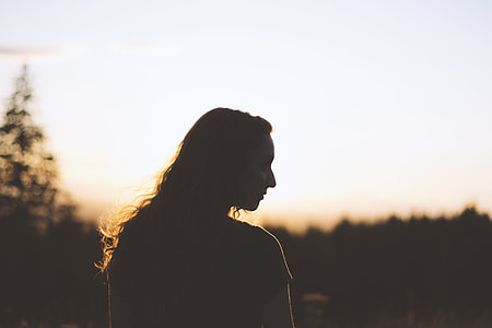 silhouette of woman and tress during sunset thumbnail