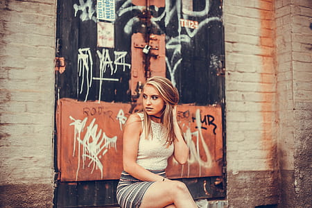 photography of woman in white tank top sitting thumbnail