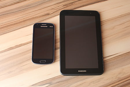 black Samsung Galaxy smartphone near Samsung smart tablet thumbnail
