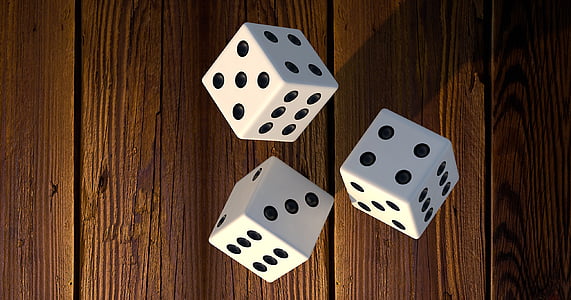 three die on brown surface thumbnail