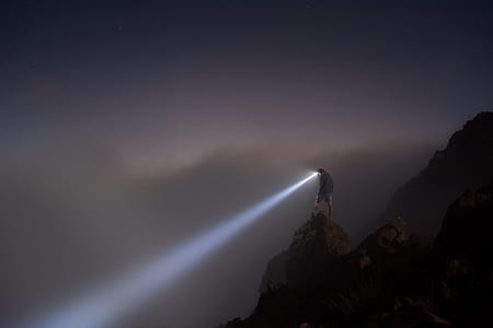 person standing on mountain with LED headlight thumbnail