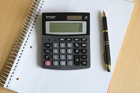 black Stylex calculator beside black twist pen thumbnail
