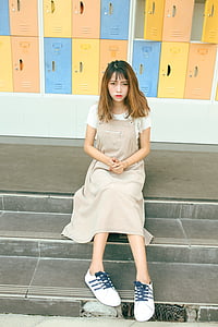 woman wearing white shirt and beige dress thumbnail