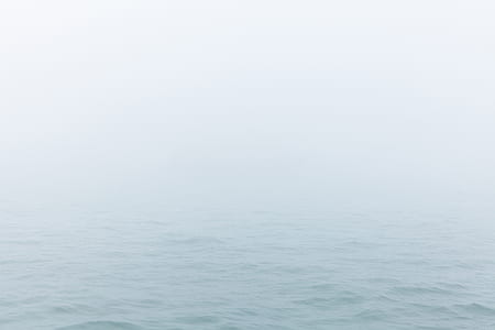 body of water covered with fog thumbnail