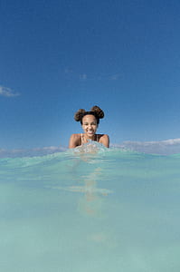 woman with shoulder and head emerging from body of water at daytime thumbnail