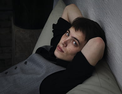 man leaning on gray lumbar pillow thumbnail
