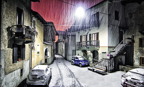 cars park near concrete building during night thumbnail