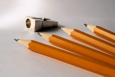 four brown pencils near gray sharpener thumbnail