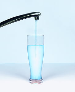 clear drinking glass under gray steel faucet thumbnail
