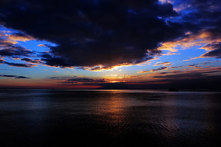 body of water under cloudy sky thumbnail