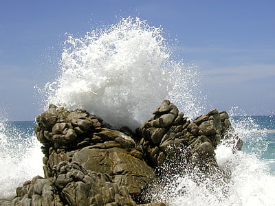 rock formation with ocean wave during daytime thumbnail