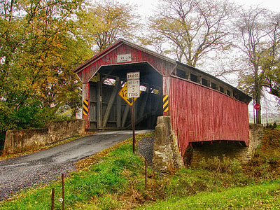 photography of red and gray steel tunnel during daytime thumbnail