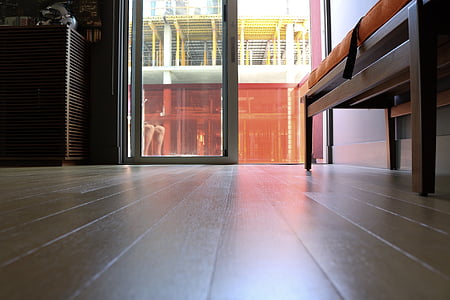 fabric and wooden bench near wall in front of door thumbnail