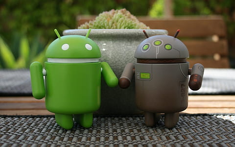 two green and gray Android figurine beside gray flowerpot thumbnail
