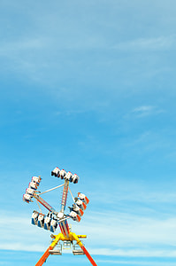yellow, white, and orange extreme ride with blue sky thumbnail