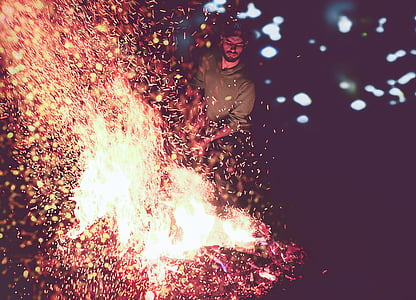 man standing in front of bonfire thumbnail