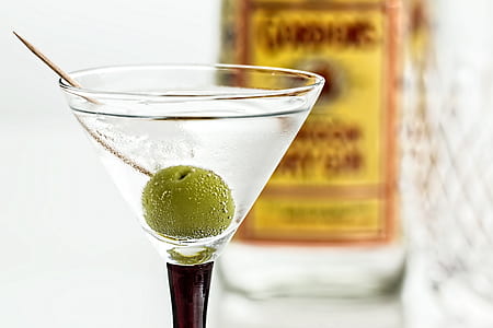 close-up photo of cocktail glass with white wine and green cherry top thumbnail