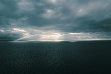 body of water under crepuscular rays thumbnail