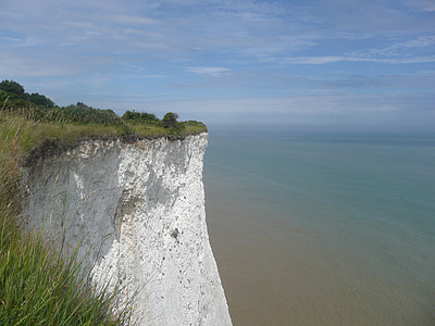 hill near body of water at daytime thumbnail