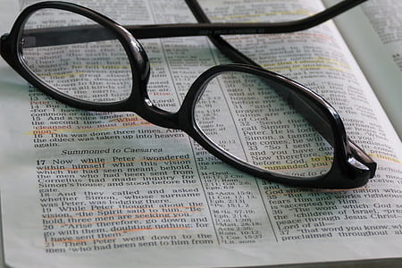 black framed eyeglasses on top of opened book thumbnail