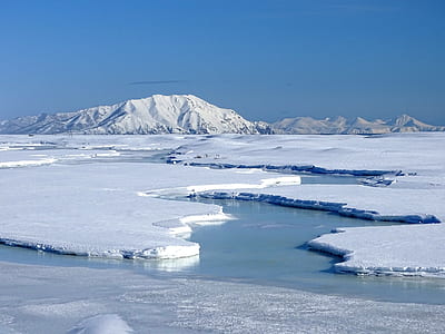 mountain cover by snow under blue sky thumbnail