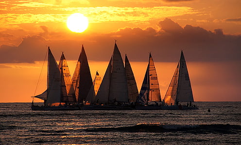 group sailing boat on body of water during sunset thumbnail