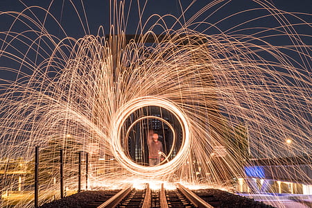 man in front of train railroad steel wool photography thumbnail