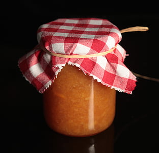 glass jar covered with white and red fabric cloth thumbnail