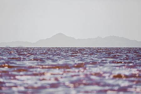 body of water in distant of mountains thumbnail