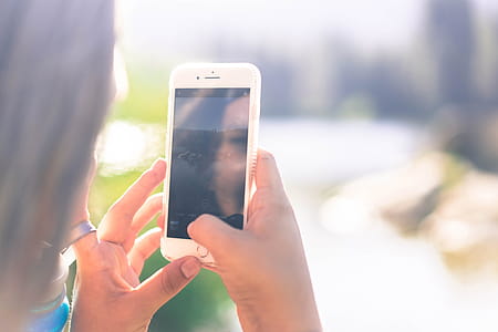 Woman Using White iPhone thumbnail