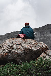 man sitting on rock monolith thumbnail