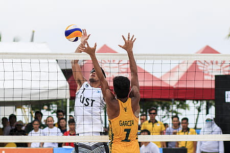 Two Men Playing Volleyball Near Red Canopy thumbnail