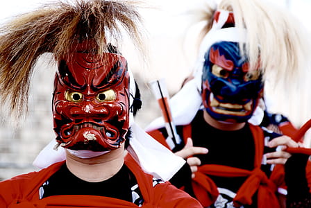 Person's Wearing Red and Blue Kabuki Masks thumbnail