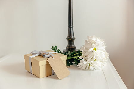 Gift With Flowers On Bedside Table Photo thumbnail
