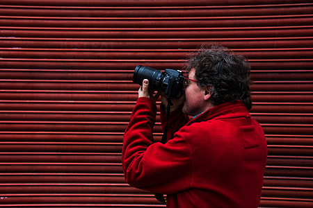 man capturing image using DSLR camera thumbnail