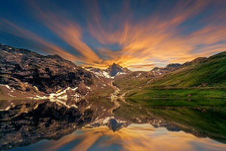 photography of mountains and hills with body of water thumbnail