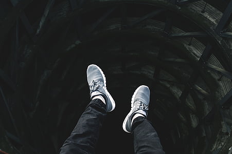 person wearing white-and-gray shoe and black pants thumbnail