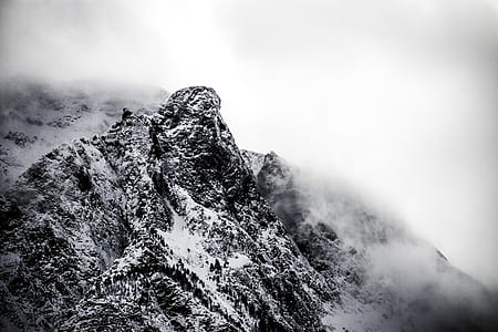 gray mountain covered with snow and fog thumbnail