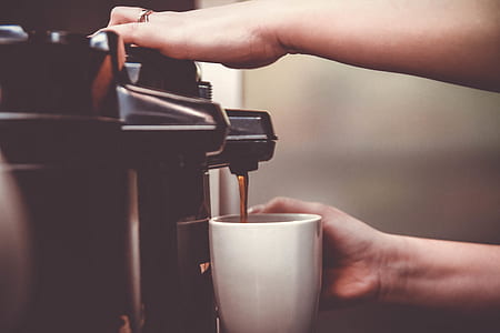 person pouring coffee in coffee cup thumbnail