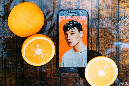 black Samsung Galaxy Android smartphone beside of sliced oranges thumbnail