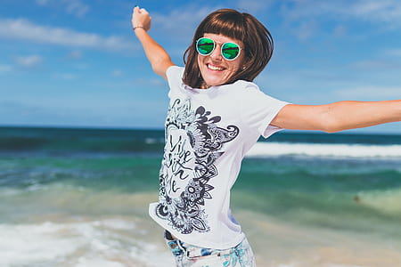 woman jumping in front of body of water thumbnail